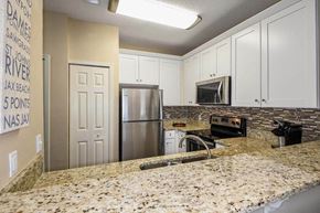 Jacksonville Beach apartment for rent - a kitchen with a granite counter top and a stainless steel refrigerator  at Ocean Park, Jacksonville Beach, 32250