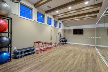 A workout room with a treadmill and weights