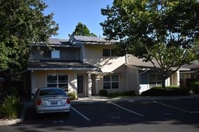 Davis townhouse for rent - A car is parked in a parking lot in front of a building.