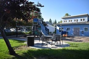 Davis townhouse for rent - A playground with a slide and a picnic table.