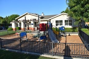 Davis townhouse for rent - A playground with a slide and a house in the background.