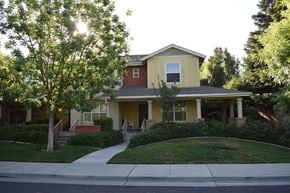 Davis townhouse for rent - A house with a red roof and a yellow front.