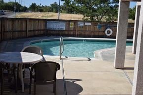 Davis townhouse for rent - A pool with a table and chairs in front of it.