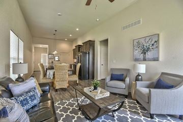 Gardner triplex for rent - A living room with a black and white rug and a coffee table.