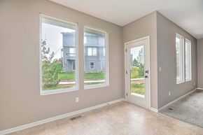 Olathe triplex for rent - a living room with three large windows and a door