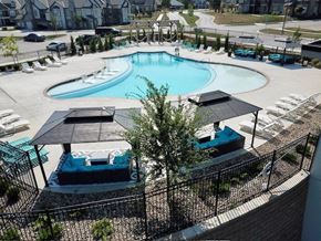 Olathe apartment for rent - an aerial view of a swimming pool with chairs and tables