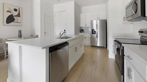 Tucson apartment for rent - A modern kitchen with white cabinets and stainless steel appliances.at Aerie La Cholla, Tucson Arizona