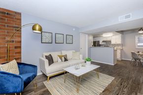 Tucson apartment for rent - A living room with a blue chair and a white couch.