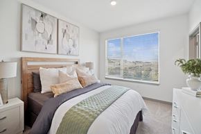 Denver apartment for rent - A bedroom with a large bed and two wall art pieces.