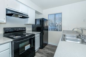 Sierra Vista apartment for rent - A black stove and refrigerator in a white kitchen.