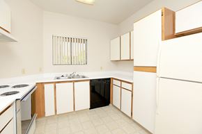 Tucson apartment for rent - A kitchen with white cabinets and a black dishwasher.