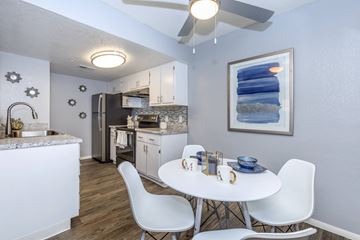 Tucson apartment for rent - A kitchen with a table and chairs in the middle of the room.