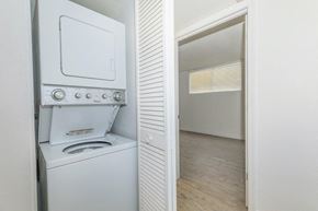 Tucson apartment for rent - A white oven with a stove top and a microwave is in a kitchen.
