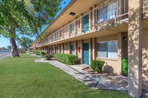 Tucson apartment for rent - A row of apartment buildings with blue doors and windows.