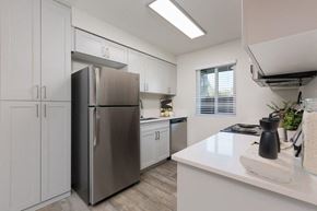Phoenix apartment for rent - a kitchen with white cabinets and a stainless steel refrigerator