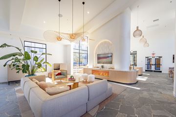 Henderson apartment for rent - A living room with a large couch and a chandelier.