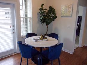 Dickinson apartment for rent - A dining room with a round table and blue chairs.