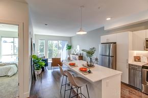 Shoreline apartment for rent - A kitchen with a white counter top and a refrigerator.