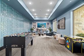 Kyle apartment for rent - A room with a pool table and a foosball table.