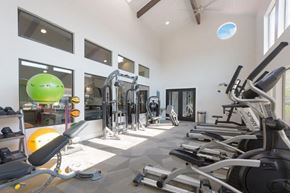 Phoenix apartment for rent - a gym with weights and a green ball on the floor