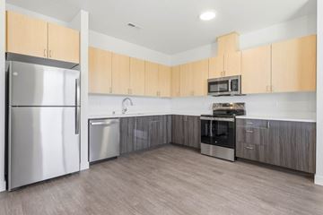 Richland apartment for rent - A kitchen with wooden cabinets and stainless steel appliances.