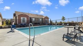 Richland apartment for rent - A pool with a diving board and a building in the background.