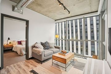 Portland apartment for rent - A living room with a grey couch and a wooden coffee table.