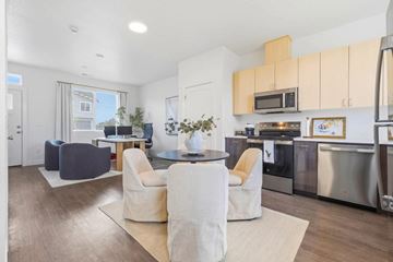 Richland apartment for rent - A modern kitchen with a dining table and chairs in the middle of the room.