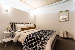 Portland apartment for rent - a bedroom with a bed and a black and white blanket