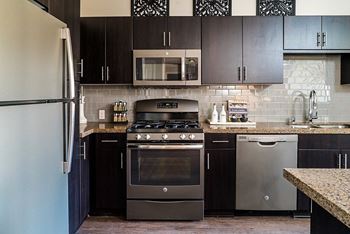 Fully appointed kitchens with designer finishes: elegant glass backsplash or subway tile in kitchens
