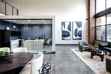 Omaha apartment for rent - A modern living room with a dining table and chairs.
