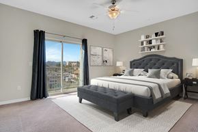 Tucson apartment for rent - A bedroom with a large bed and a view of the city.