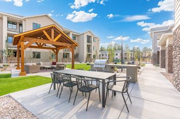 Outdoor patio and lawn area with gaming lawn and firepit for relaxing
