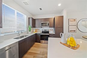 Denver apartment for rent - A modern kitchen with wooden cabinets and stainless steel appliances.