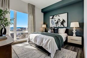 Seattle apartment for rent - a bedroom with a bed and a large window