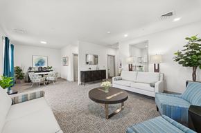 Salem apartment for rent - A living room with a white couch, a coffee table, and a fireplace.