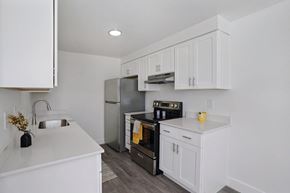 Layton apartment for rent - A kitchen with white cabinets and appliances.
