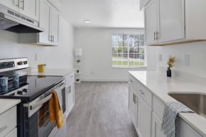 Layton apartment for rent - A kitchen with white cabinets and a black stove top.