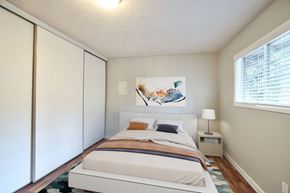 Vancouver apartment for rent - Bedroom with white walls, window, and spacious closet at The Groove apartments in the Hazel Dell 98665 neighborhood in Vancouver, Washington.