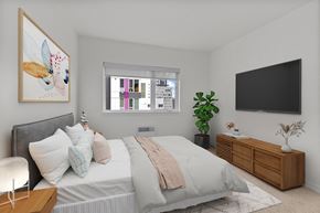Seattle apartment for rent - a bedroom with a large bed and a tv