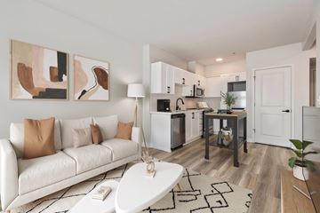 Seattle apartment for rent - A modern living room with a white couch and a coffee table.