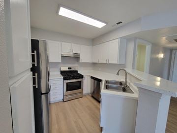 Draper apartment for rent - a kitchen with white cabinets and stainless steel appliances