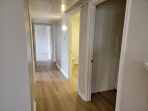 Draper apartment for rent - a passageway between two bedrooms and a hallway with a door to a bathroom