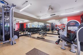 Bellevue apartment for rent - a gym with weights and cardio machines and a red wall