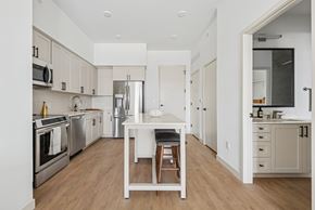 Salt Lake City apartment for rent - A kitchen with a table and chairs in the middle.