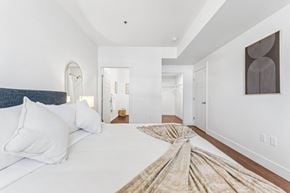 Richland apartment for rent - A bedroom with a large bed and a painting on the wall.