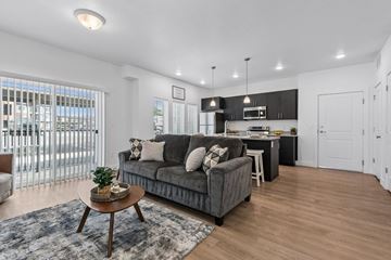 Tooele apartment for rent - A modern living room with a grey sofa and a coffee table.