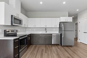 Post Falls apartment for rent - A modern kitchen with stainless steel appliances and wooden floors.