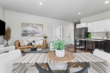 Post Falls apartment for rent - A modern living room with a glass table and white chairs.