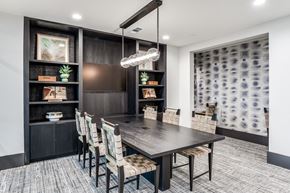 Lewisville apartment for rent - A modern dining room with a dark wood table and chairs.
